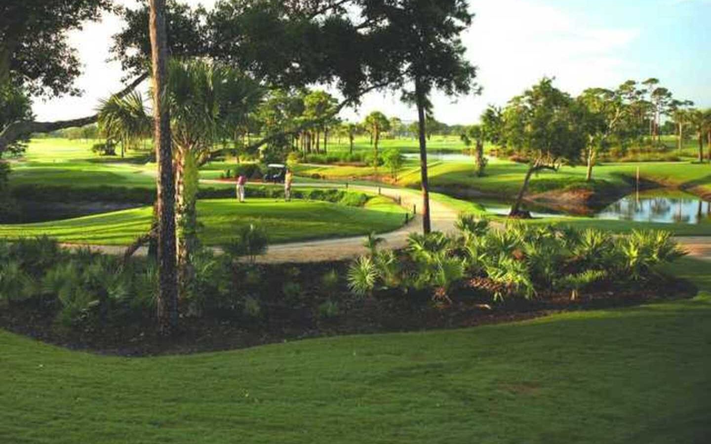 Landscaped golf course with flowering beds and mature trees