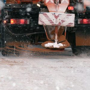 Trucks spreading salt are essential for winter deicing but cause salt damage to lawns and landscapes.